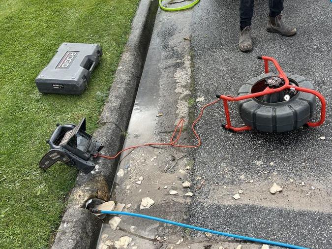 Drain cleaning hose and equipment beside a path, Beaumaris