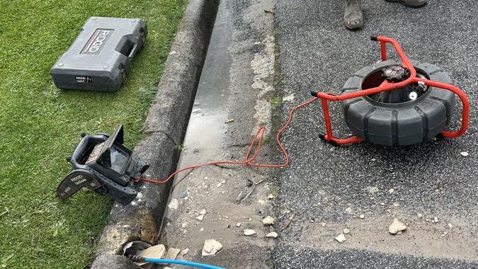 Drain cleaning hose and equipment beside a path, Beaumaris